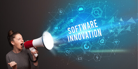 Young woman shouting in megaphone with SOFTWARE INNOVATION inscription, Modern technology announcement concept