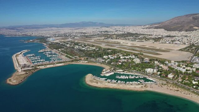 Aerial drone video of Marina of Agios Kosmas and abandoned former international airport of Athens in Elliniko area, South Athens riviera, Attica, Greece