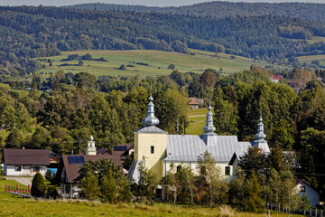 Former Greek-Catholic Lemko church building built in Smerekowiec village in 1818 year. Beskid Niski mountains landscape. - obrazy, fototapety, plakaty