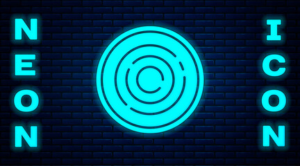 Glowing neon Checker game chips icon isolated on brick wall background. Vector.
