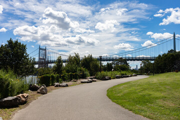 Fototapeta premium Empty Riverfront Path on Randalls and Wards Islands with the Triborough Bridge during the Summer in New York City
