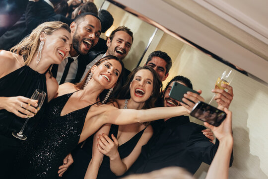 Socialites taking a selfie at party
