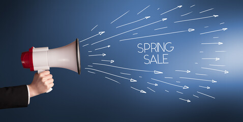 Young girl screaming to megaphone with SPRING SALE inscription, shopping concept