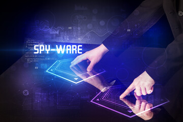 Hand touching digital table with SPY-WARE inscription, new age security concept