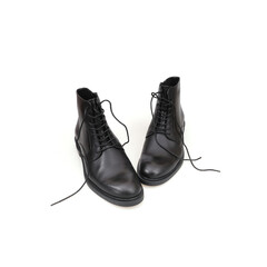 Fashionable black boots for men and women isolated on white background