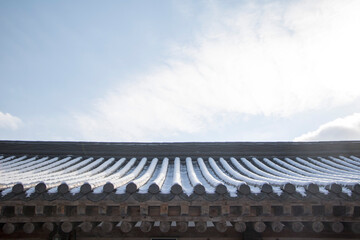 Korean temple roof covered in snow                 
