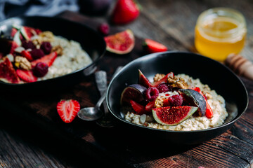 Oatmeal with figs, chia, raspberries and strawberries. Healthy Breakfast