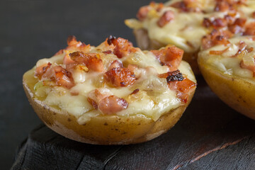 Hot baked stuffed potatoes with cheese, bacon, parsley.