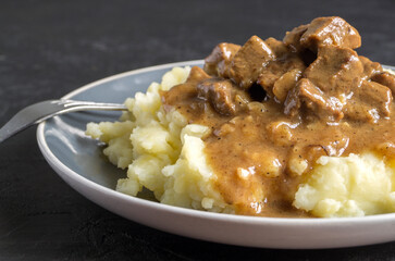 stewed meat in gravy and mashed potatoes.