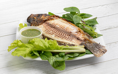 Grilled Tilapia freshwater fish with green vegetable