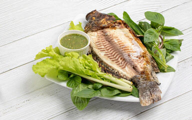 Grilled Tilapia freshwater fish with green vegetable