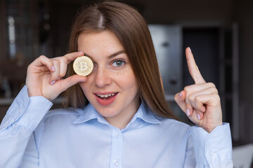 Business woman with idea to make money. Holds bitcoin gold coin. Business concept