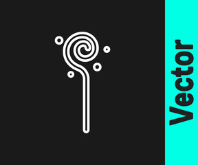 White line Magic staff icon isolated on black background. Magic wand, scepter, stick, rod. Vector.