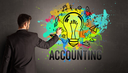 businessman drawing colorful light bulb with ACCOUNTING inscription on textured concrete wall, new business idea concept