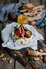 baked Camembert cheese with figs, nuts, honey and rosemary