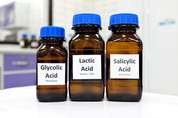 Selective focus of salicylic, lactic and glycolic acid liquid solution in dark brown glass bottle...