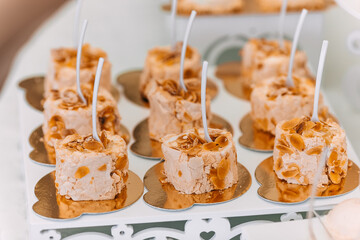 close up of tasty dessert with peanuts on a gilded stand. weddin