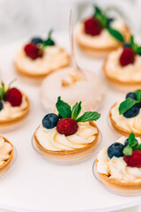 closeup of sand dough baskets with cream and berries. wedding pa