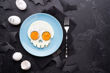 Fried eggs in the shape of a skull. Halloween breakfast.