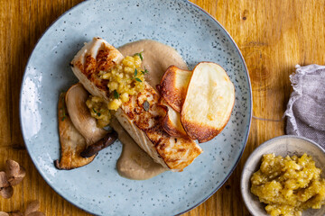 Pan fried halibut with mushroom velute, hazelnut pesto and potato crisps