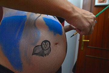 Belly painting on a pregnant woman