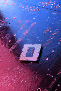 Computer cpu processor chip on circuit board ,motherboard background. Close-up. With red-blue lighting