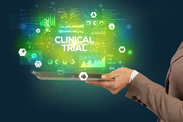 Close-up of a touchscreen with CLINICAL TRIAL inscription, medical concept