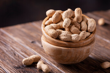  Roasted peanuts in wooden bowl