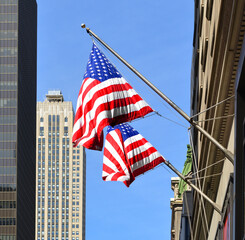 American flags against backdrop of New York City skyscrapers. United States