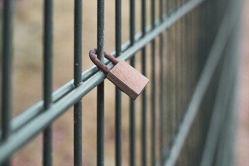  locked padlock hangs on a fence