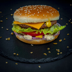 Cheeseburger on a black stone tray