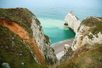 The nice high cliffs on the shore by the city of Étretat in Normandy in France. Famous tourist attraction. 
