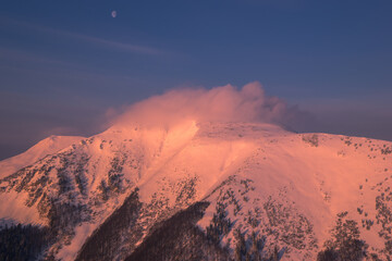 mountain shrouded in mist at sunrise