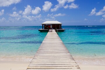 Wooden walkway in the middle of the tropical turquoise sea water of Guadeloupe island 