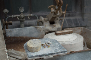 a close up of some nails and a pottery sponge next to some tools of the trade.