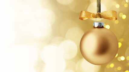 Christmas and New Year greeting card. Holiday ornament, winter decoration. Golden christmas ball hanging on ribbon over bokeh background, with copy space