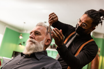 african american barber with mask coronavirus pandemic prevention comb white caucasian male with...