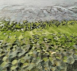 Balangan Beach and eroded rocks with green moss in Bali, Indonesia