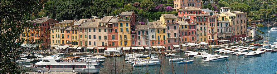 Fototapeta na wymiar Portofino is a fishing village on the Ligurian Riviera south-east of Genoa, pastel-colored houses overlooking the cobbled square overlooking the harbor