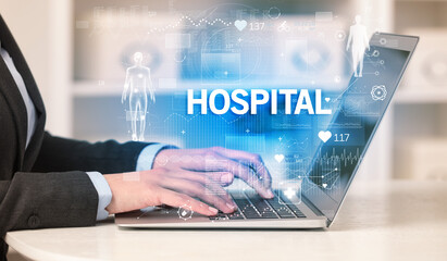 Doctor working a health check with HOSPITAL inscription, recording medical test results