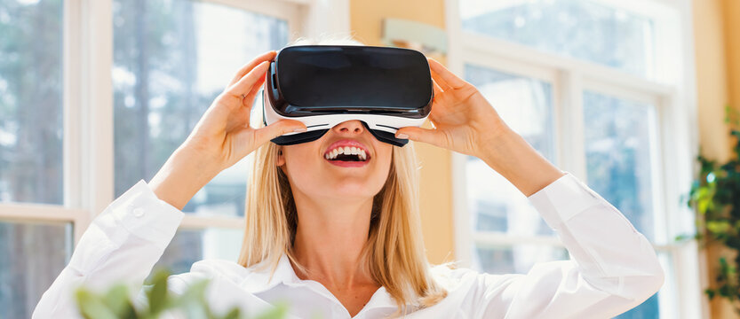 Happy young woman using a virtual reality headset