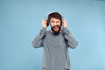 man wearing headphones music emotion lifestyle modern style technology blue background