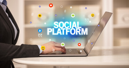 Freelance woman using laptop with SOCIAL PLATFORM inscription, Social media concept