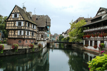 Fototapeta na wymiar The center of the French city of Strasbourg with the canals and river and many historic houses. 