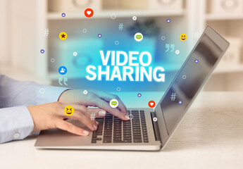 Freelance woman using laptop with VIDEO SHARING inscription, Social media concept