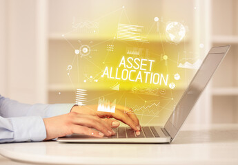 Side view of a business person working on laptop with ASSET ALLOCATION inscription, modern business concept