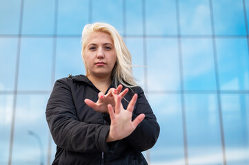 Emotional deaf and dumb woman talking sign language outdoors.