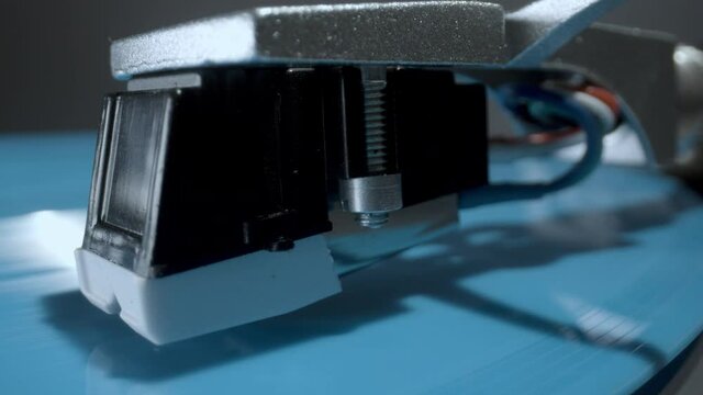 Stylus on record player with blue vinyl