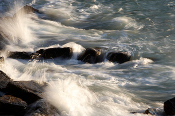 Wave breaking against the cliffs in a windy day