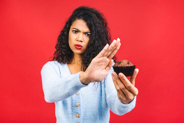 American african girl does not eat cake. Conception to lose weight. Hand gesturing no to a cake....